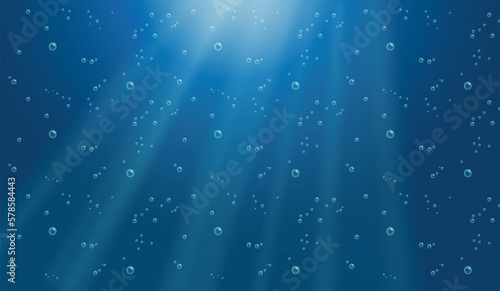 Underwater background with water bubbles and undersea light rays shine