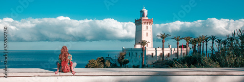 Woman tourist looking at lighthouse of Cap Spartel, Tanger, Morocco in Africa