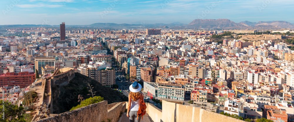 Alicante city panoramic view and traveler woman looking at viewpoint-  Spain