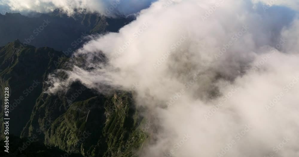 Low Fluffy Clouds Over Pico do Arieiro Peak During Sunrise In Madeira Island, Portugal. Aerial Shot Low Fluffy Clouds Over Pico do Arieiro Peak During Sunrise In Madeira Island, Portugal. Aerial Shot