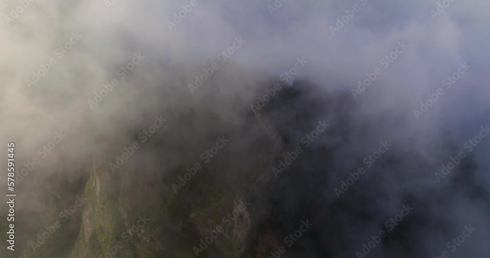 Foggy Clouds Enveloping Pico do Arieiro In Madeira Island, Portugal. Aerial Shot Foggy Clouds Enveloping Pico do Arieiro In Madeira Island, Portugal. Aerial Shot