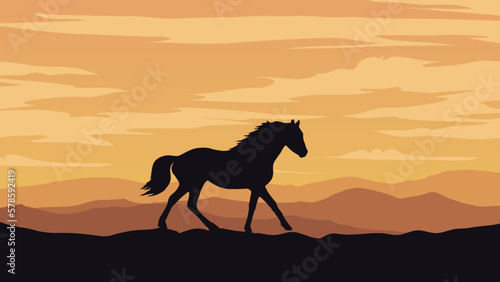 a horse is walking across a hill at sunset or dawn, mountain range
