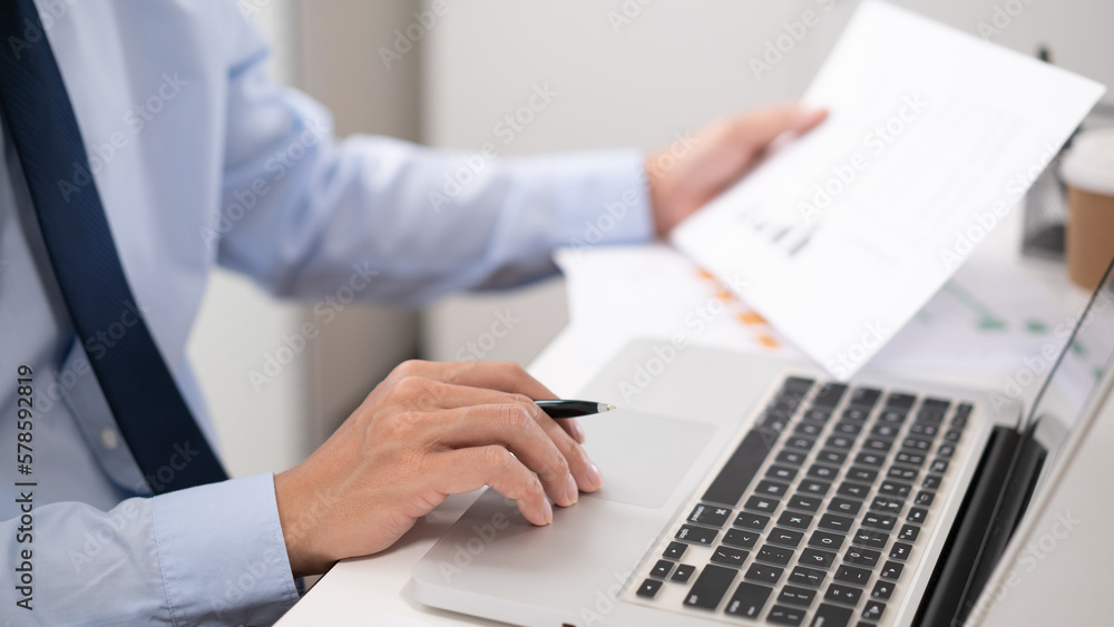Business man working by using laptop computer Hands typing on a keyboard. Professional investor working new start up project. business planning in office. Technology business Business man working by using laptop computer Hands typing on a keyboard. Professional investor working new start up project. business planning in office. Technology business