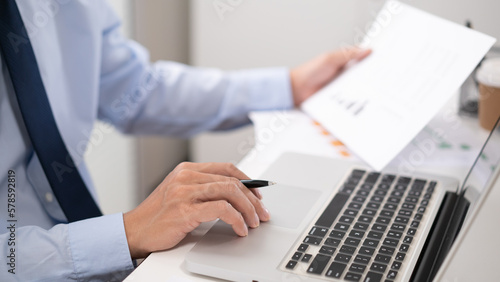 Business man working by using laptop computer Hands typing on a keyboard. Professional investor working new start up project. business planning in office. Technology business