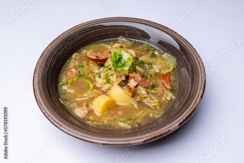 Slovak soup from sauerkraut, potatoes and smoked meat