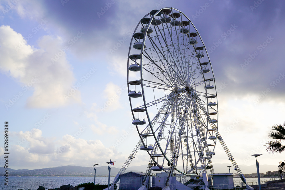Giant ferris wheel funfair park against blue sky