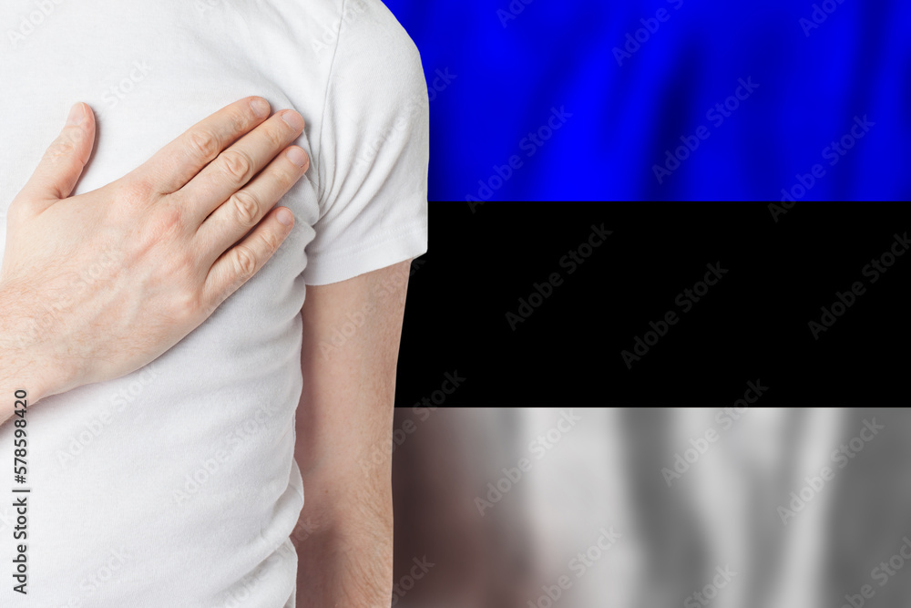 Estonian person with hand on heart on the background of Estonia flag. Patriotism, country, national, pride concept