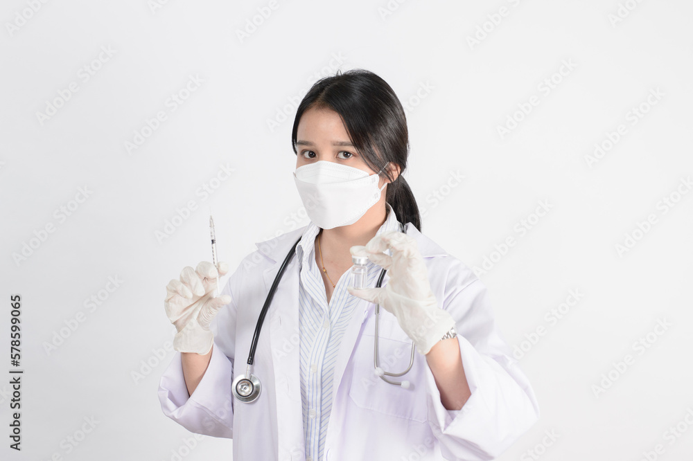Study of COVID-19 infection. Female doctor examines medicine for illness, man mask with syringe and jar in front with copy space coronavirus virus Study of COVID-19 infection. Female doctor examines medicine for illness, man mask with syringe and jar in front with copy space coronavirus virus