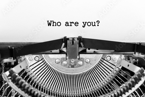 Who Are You phrase closeup being typing and centered on a sheet of paper on old vintage typewriter mechanical