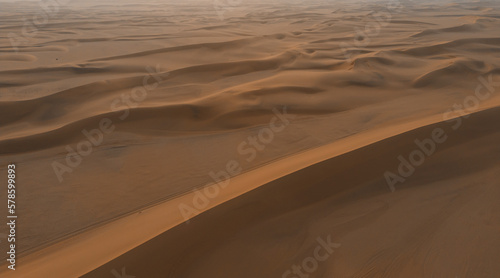 Aerial top view of Namib Desert Safari with sand dune in Namibia, South Africa. Natural landscape background at sunset. Famous tourist attraction. Sand in Grand Canyon © tampatra