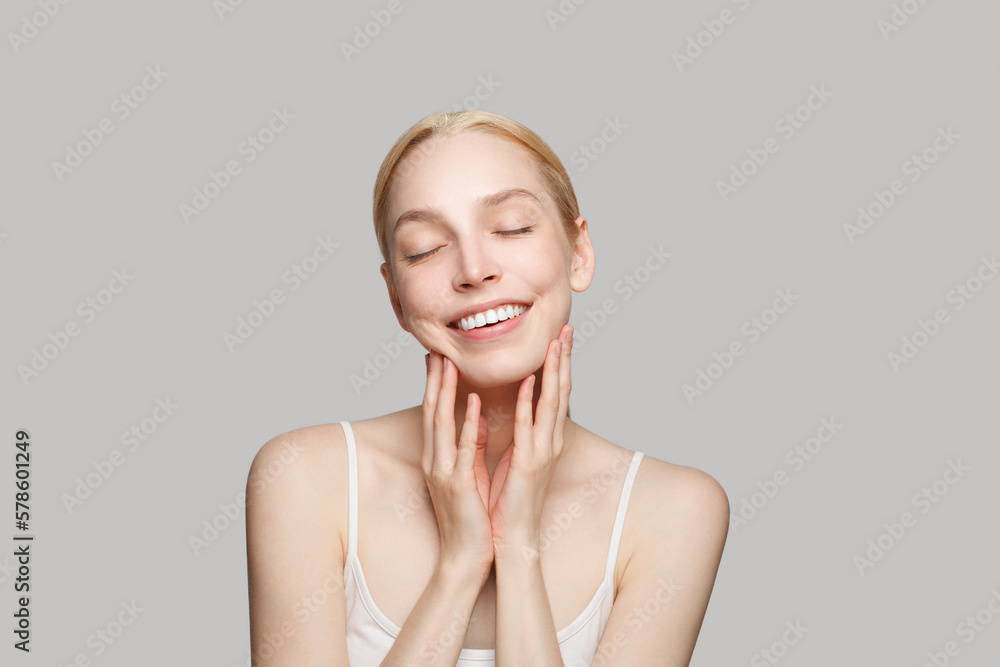 Portrait of beautiful woman and her hands  isolated on grey background. Beauty, cosmetics, skincare, glamour