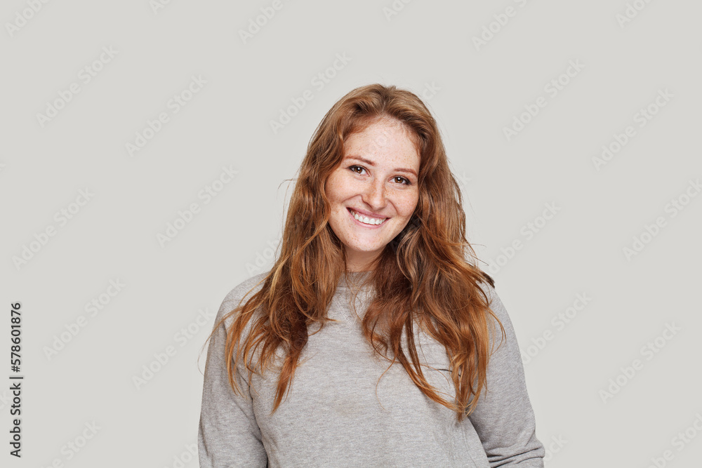 Portrait of beautiful real woman with cute friendly smile posing against white studio wall background Portrait of beautiful real woman with cute friendly smile posing against white studio wall background