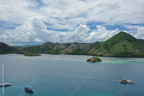 Idlillic panorama shot from the top of the hill of Kalor Island in Komodo National Park on Flores, below the sea, in the background hills.