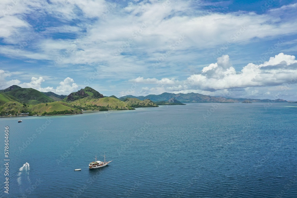 Idlillic panorama shot from the top of the hill of Kalor Island in Komodo National Park on Flores, in the foreground the sea, on the left hills.