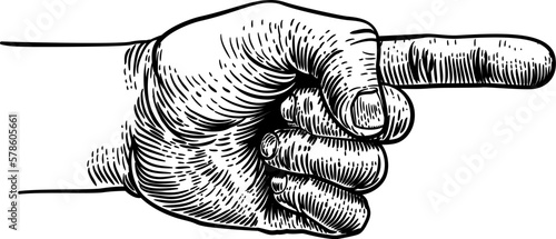 A hand pointing a finger in a direction sign. In a vintage antique engraving woodblock or woodcut style.