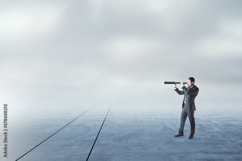 Businessman with telescope looking into the distance on abstract dull sky and ground background with mock up place. Businessman with telescope looking into the distance on abstract dull sky and ground background with mock up place.