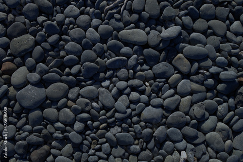 Black pebbles background texture. Horizontal wallpaper