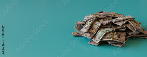 Banking Banner with Fifty Dollar Bills. Pile of Cash Bundles on Aqua surface with copy-space. photo