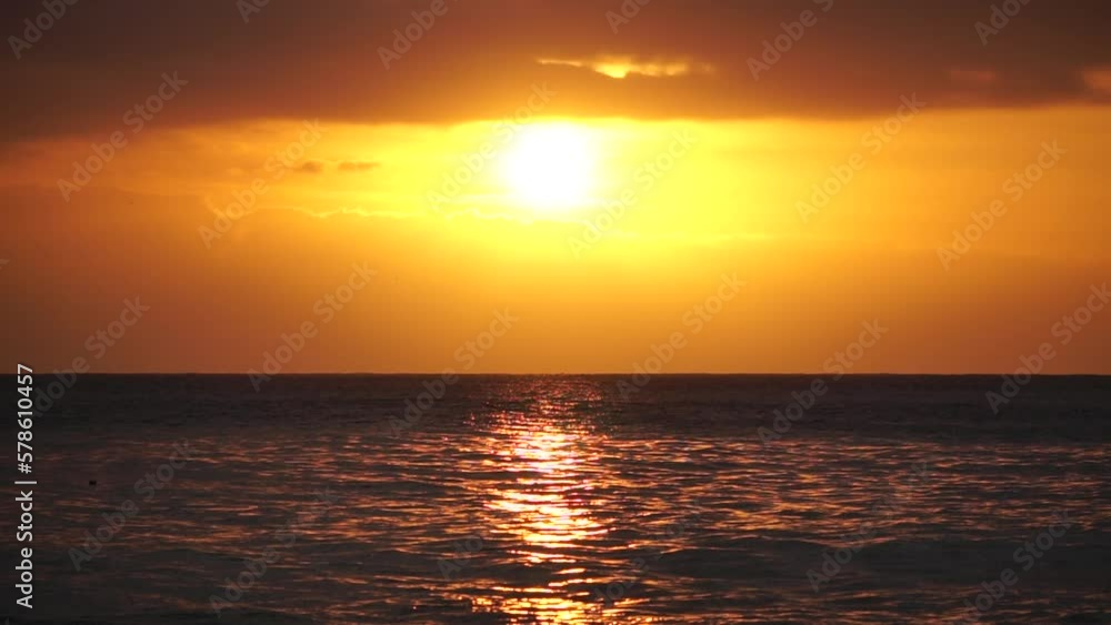 Blurred golden sea at sunset. The sun reflects and sparkles on the waves with bokeh, illuminating the golden sea. Holiday recreation concept. Abstract nautical summer ocean sunset nature background. Blurred golden sea at sunset. The sun reflects and sparkles on the waves with bokeh, illuminating the golden sea. Holiday recreation concept. Abstract nautical summer ocean sunset nature background.