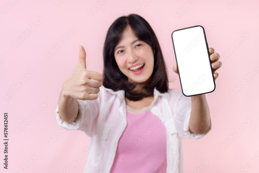 happy smiling young asian woman recommending showing new application or mobile advertisement, mockup smartphone template banner isolated on pink background. Collage blank screen digital mobile device. happy smiling young asian woman recommending showing new application or mobile advertisement, mockup smartphone template banner isolated on pink background. Collage blank screen digital mobile device.