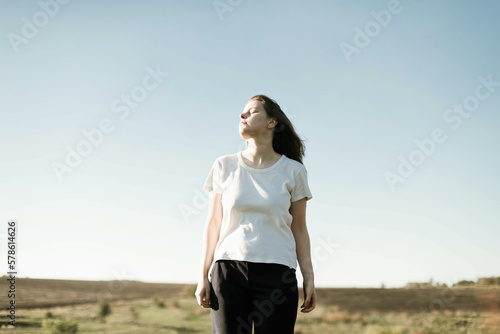 Dreamy portrait of a young brunette woman outdoor photo