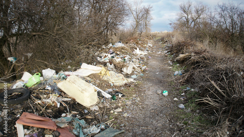 Garbage lies along the path in the village