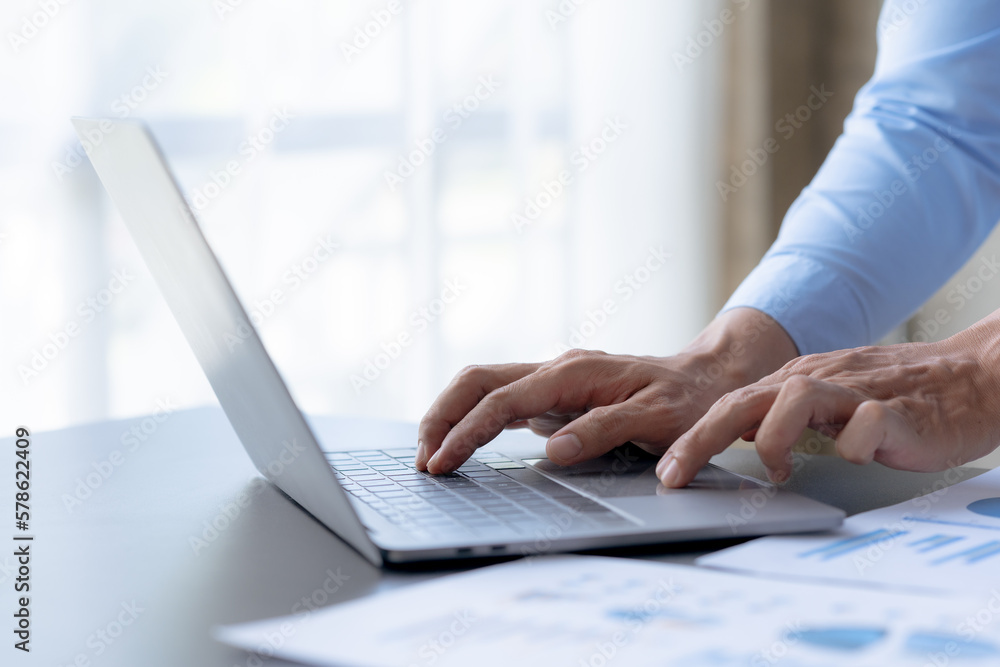 Businessman sitting using laptop computer on table in office. Businessman sitting using laptop computer on table in office.