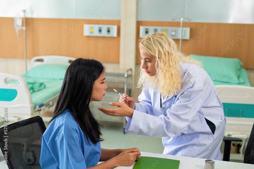 Young woman consult with doctor for botulinum toxin botox face injection at beauty treatment clinic Young woman consult with doctor for botulinum toxin botox face injection at beauty treatment clinic