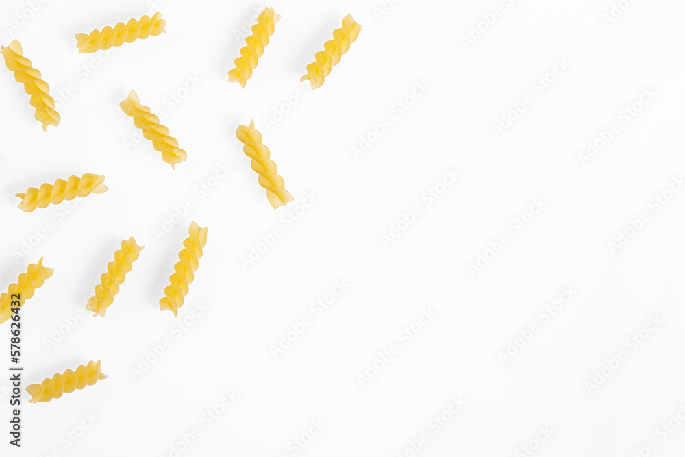 Pasta products in the form of a spiral, texture, on a white background