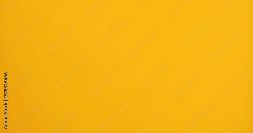 A joyful teenager girl wearing a colorful Brazil carnival mask, dancing, having fun on yellow studio background, ready for celebration, birthday party, holidays concept A joyful teenager girl wearing a colorful Brazil carnival mask, dancing, having fun on yellow studio background, ready for celebration, birthday party, holidays concept