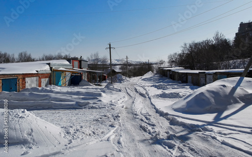 Wallpaper Mural Garage cooperative. Cooperative buildings lines for vehicle parking. An example of a collective household. Spring. White snow and Blue sky. Ust-Kamenogorsk (kazakhstan) Torontodigital.ca