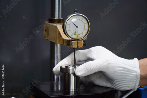 operator uses the indicator test dial on the stand for accurate measurements,Dial Test Indicator on the stand for accurate measuremen photo