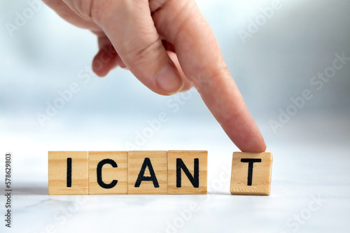 Change the word I can't to read I can concept for self belief, positive attitude and motivation, Hand removing the can't text wooden cubes background texture