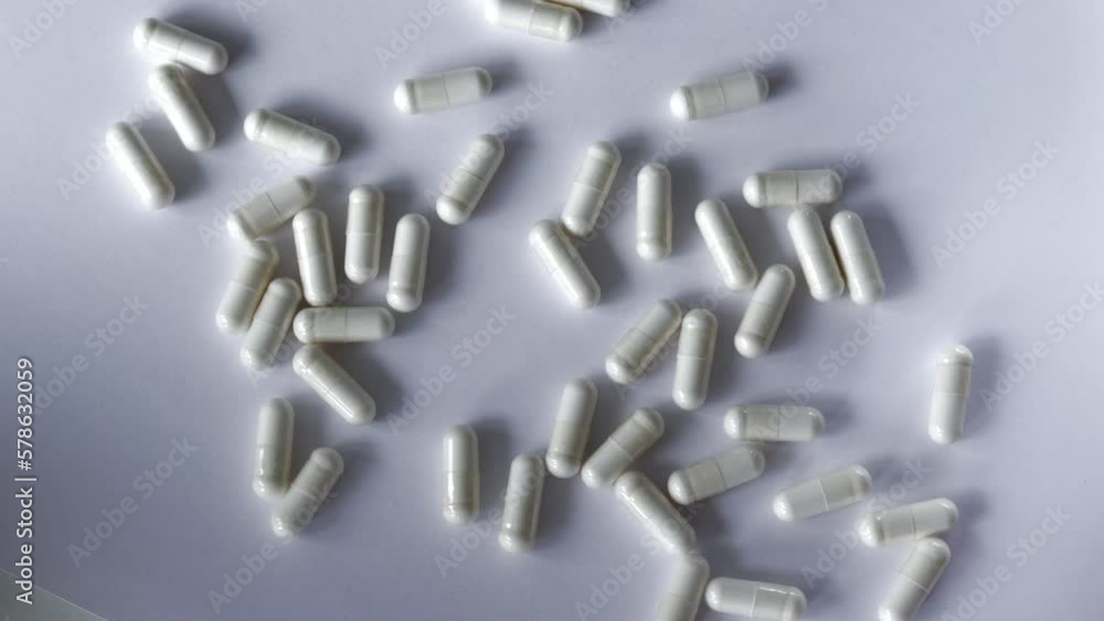 White capsules of supplements on a white background. Tablets with digestive enzymes. White capsules of supplements on a white background. Tablets with digestive enzymes.
