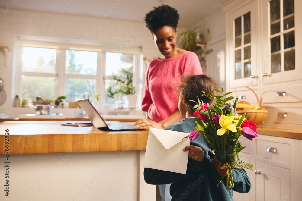 Boy giving mother bouquet and Mother's Day or Birthday card Boy giving mother bouquet and Mother's Day or Birthday card