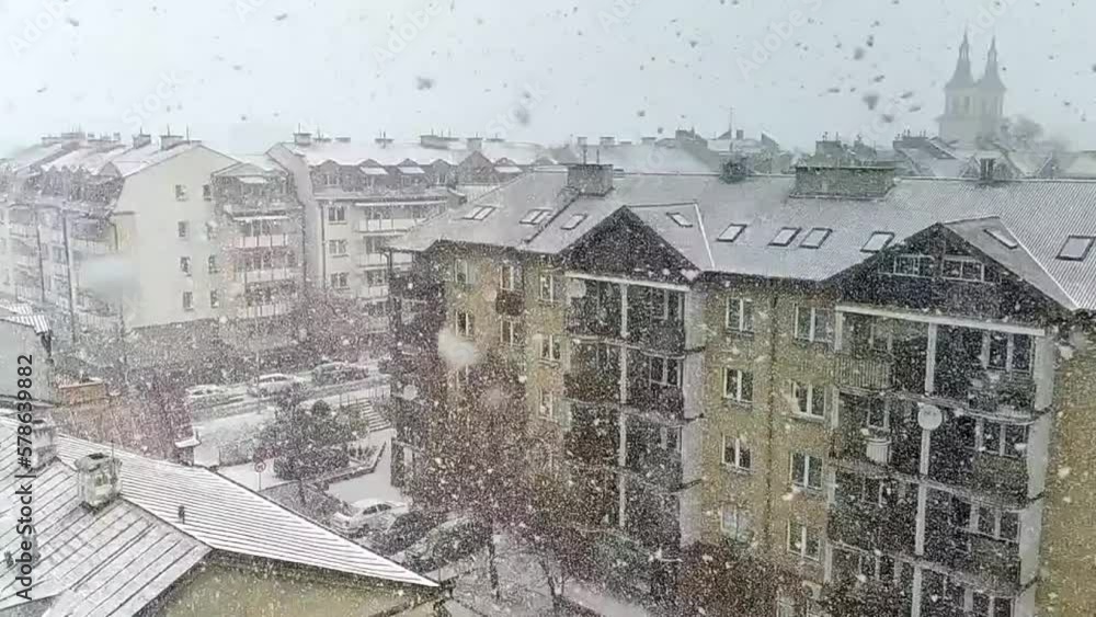 Snow is falling over the city. Slow motion video
