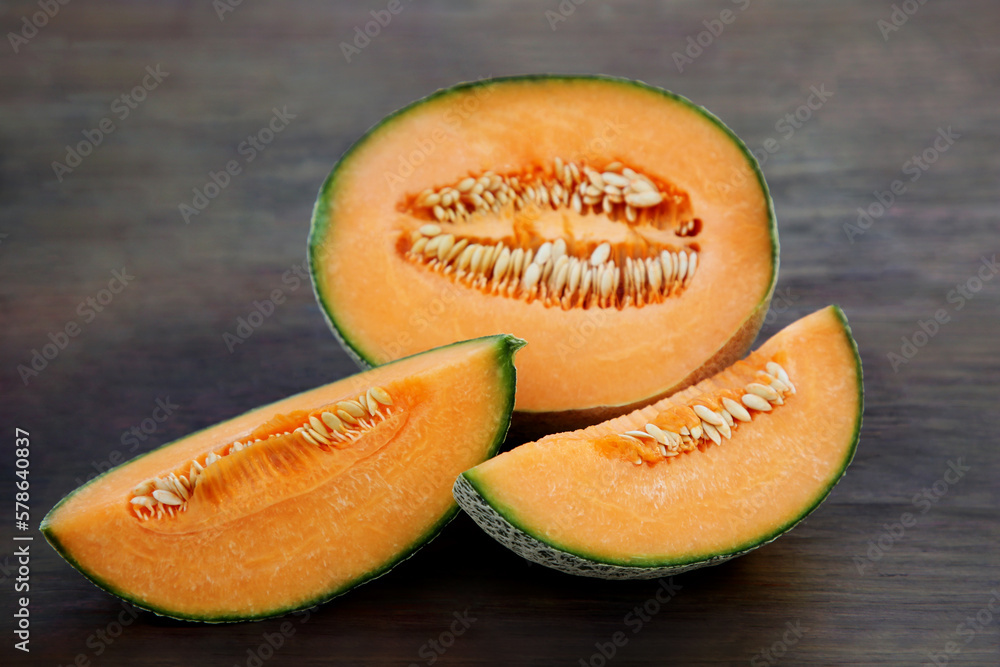 Tasty orange ripe melons on wooden table Tasty orange ripe melons on wooden table