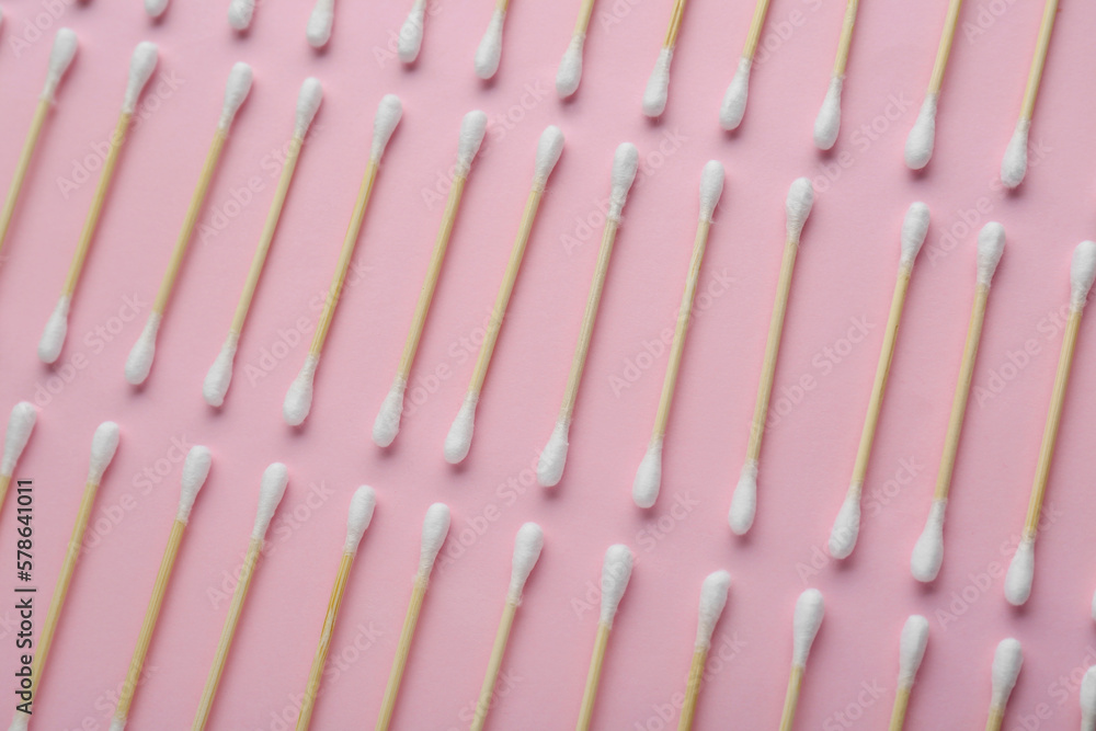 Many wooden cotton buds on pink background, flat lay Many wooden cotton buds on pink background, flat lay