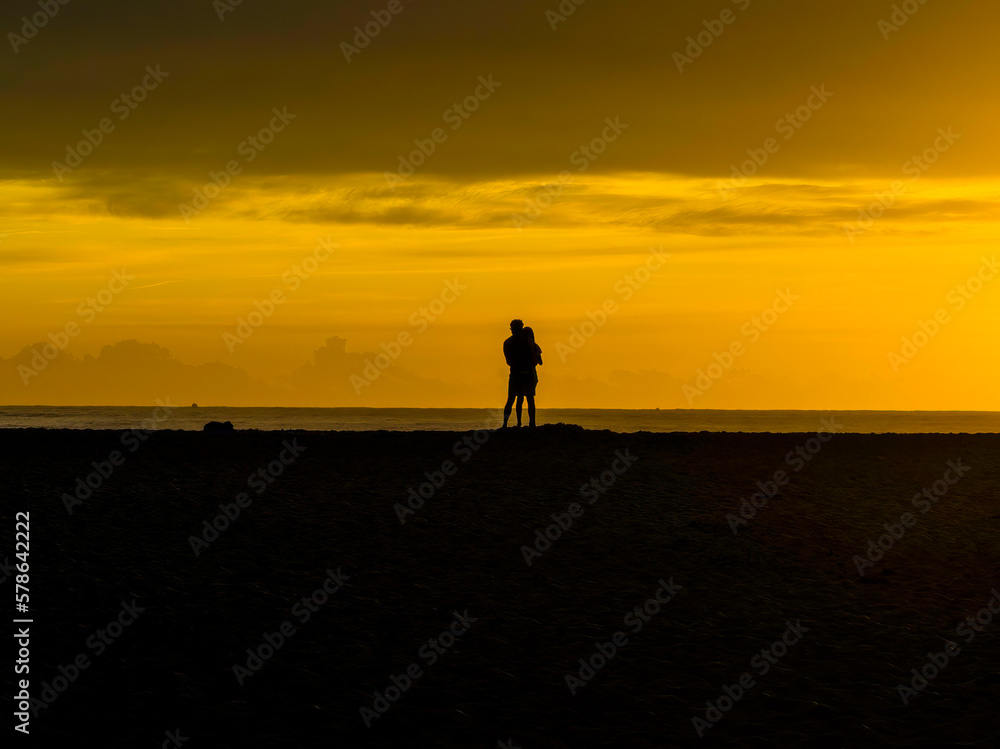 Sunrise silhouettes - golden hour romance at the seaside