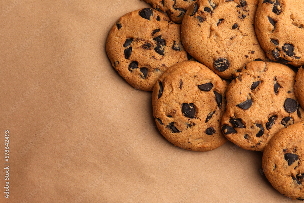Delicious chocolate chip cookies on brown background, flat lay. Space for text Delicious chocolate chip cookies on brown background, flat lay. Space for text