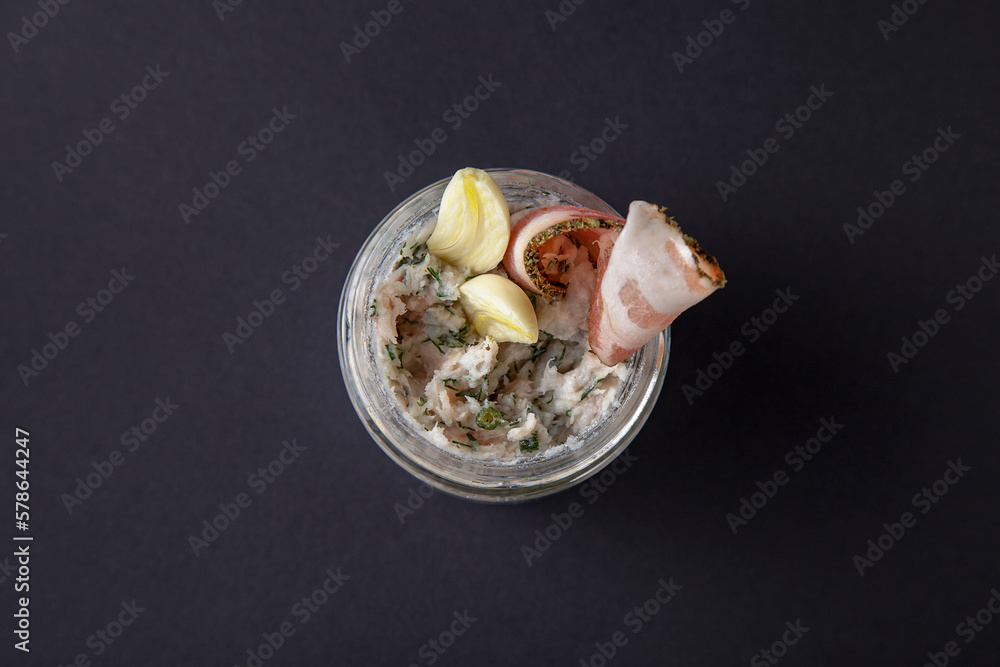 Lard in a jar with garlic and bacon