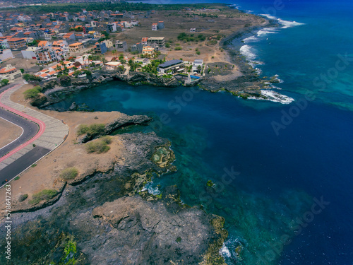 Aerial photos of Tarrafal in Santiago Island  Cabo Verde showcase the stunning beaches and clear waters of this idyllic coastal town  as well as its colorful buildings  charming streets