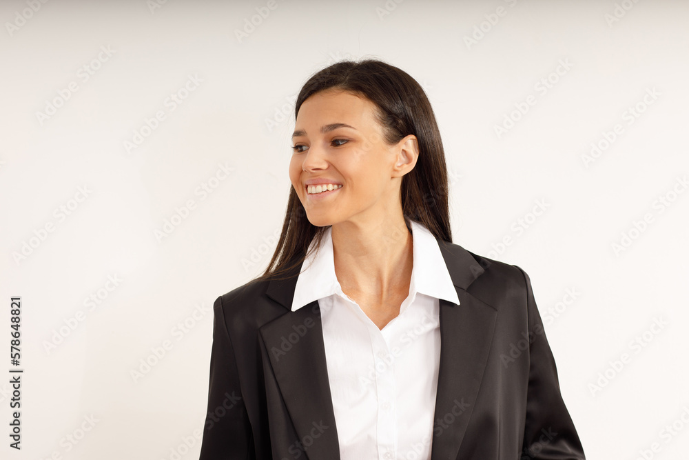 Portrait of happy smiling brunette girl dressed in white shirt and black jacket. Beautiful model on isolated white background. Studio shot of young attractive woman in business suit. Portrait of happy smiling brunette girl dressed in white shirt and black jacket. Beautiful model on isolated white background. Studio shot of young attractive woman in business suit.