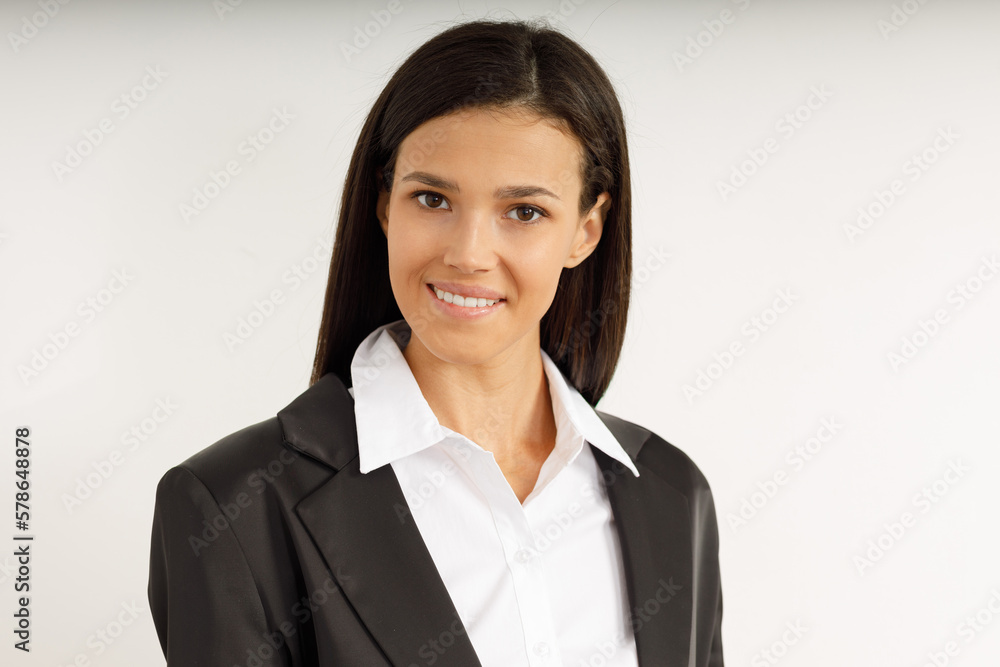 Portrait of happy smiling brunette girl dressed in white shirt and black jacket. Beautiful model on isolated white background. Studio shot of young attractive woman in business suit. Portrait of happy smiling brunette girl dressed in white shirt and black jacket. Beautiful model on isolated white background. Studio shot of young attractive woman in business suit.