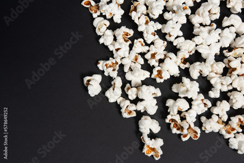 fried popcorn on a black background close-up, ready-to-eat food
