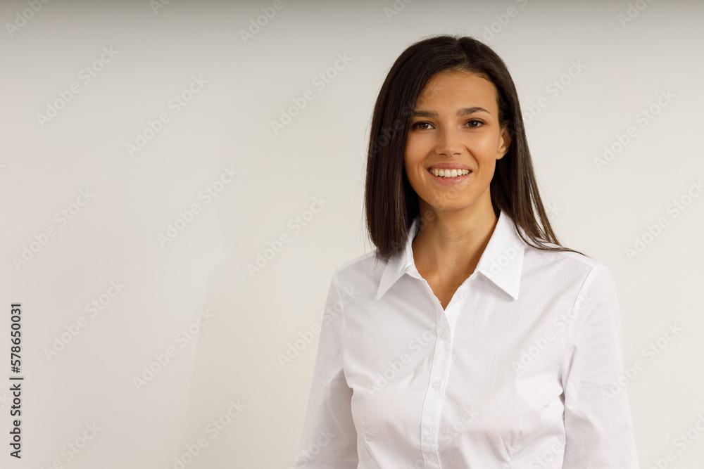 Portrait of happy smiling brunette girl dressed in white shirt. Beautiful model on isolated white background. Studio shot of young attractive woman in business suit. Portrait of happy smiling brunette girl dressed in white shirt. Beautiful model on isolated white background. Studio shot of young attractive woman in business suit.