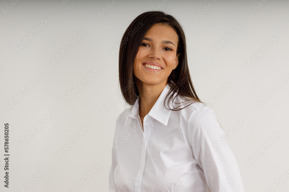Portrait of happy smiling brunette girl dressed in white shirt. Beautiful model on isolated white background. Studio shot of young attractive woman in business suit. Portrait of happy smiling brunette girl dressed in white shirt. Beautiful model on isolated white background. Studio shot of young attractive woman in business suit.