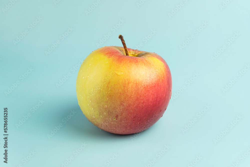 ripe red apple on a blue background ripe red apple on a blue background