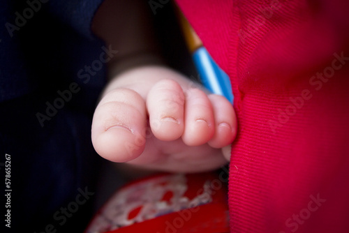 Two month old baby feet on black background