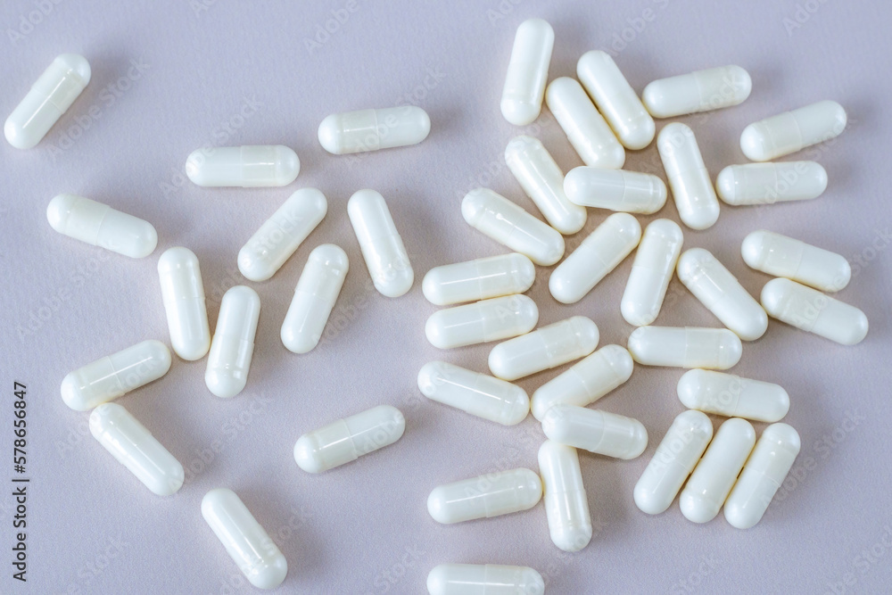 Vitamin D3 plus K2 on beige background, top view Vitamin D3 plus K2 on beige background, top view